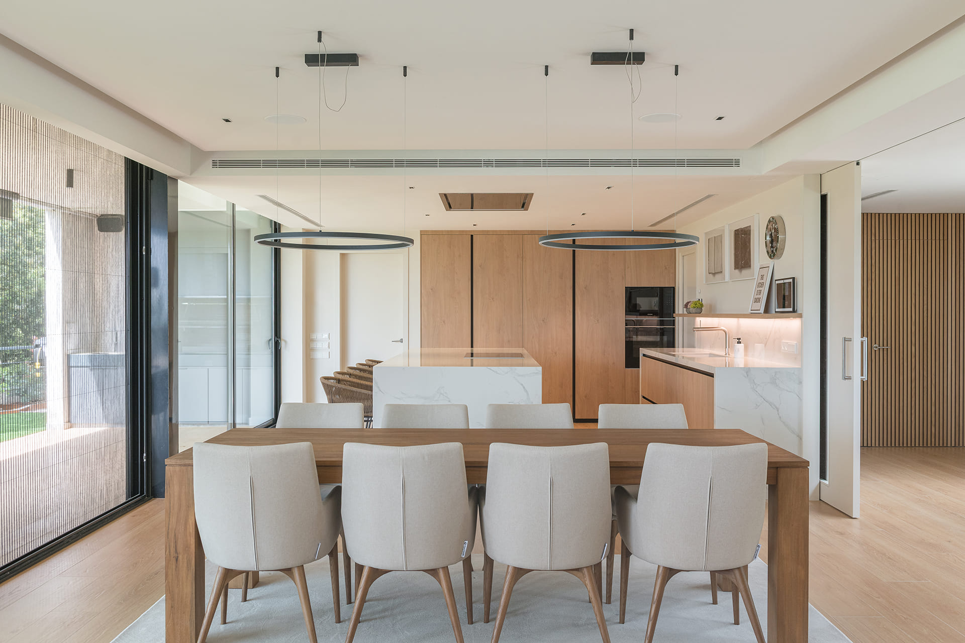 Cocina blanca Santos con acabado en Roble Natural e isla central.