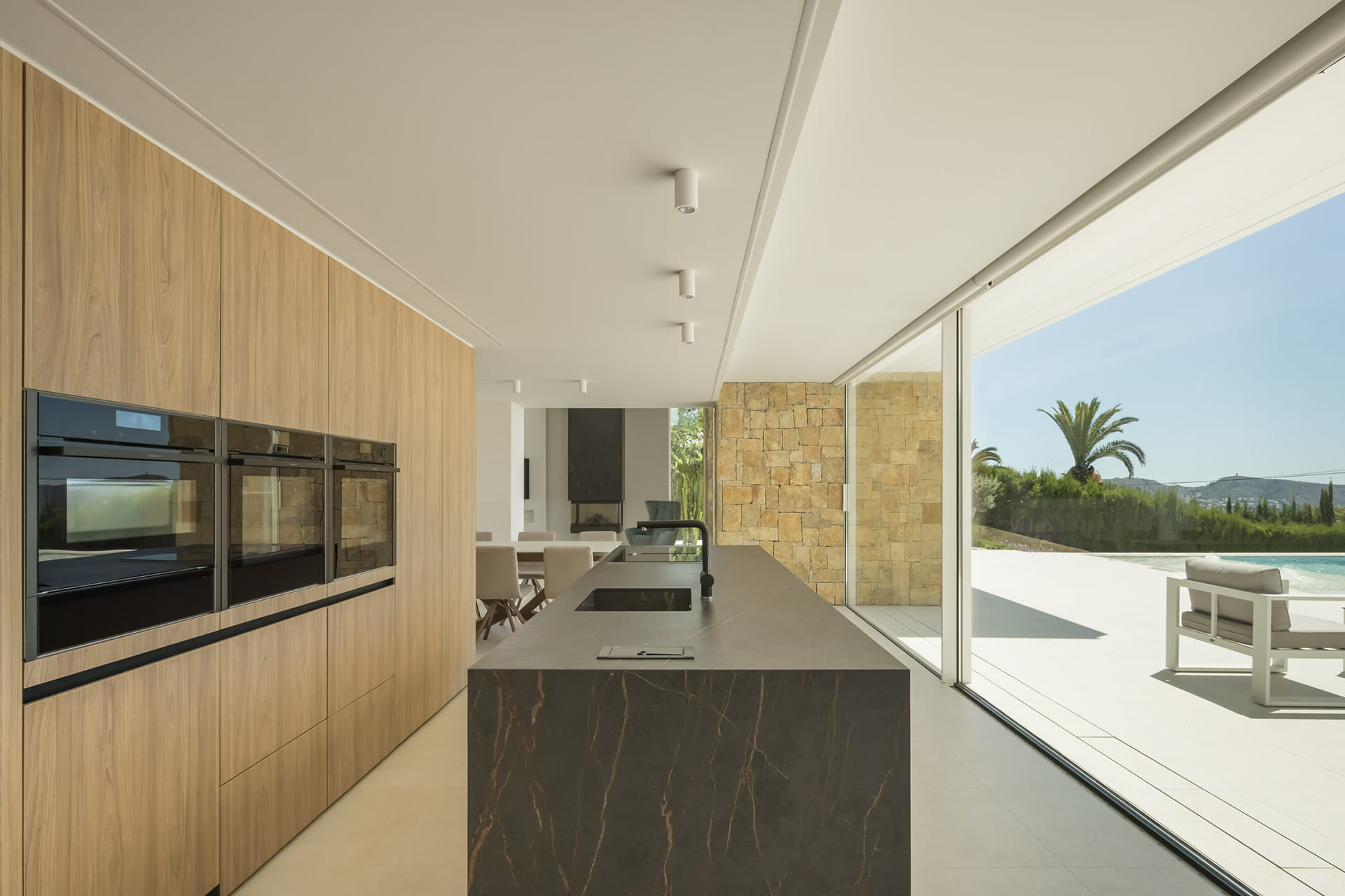 Vivienda con cocina Santos abierta a una amplia zona exterior.
