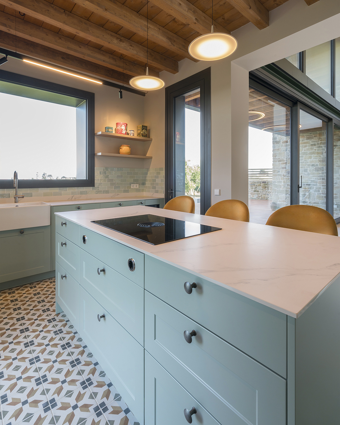 Kitchen island with drawers and integrated ceramic hob in a classic Santos kitchen.